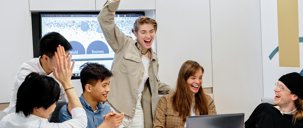 Group smiling at computer